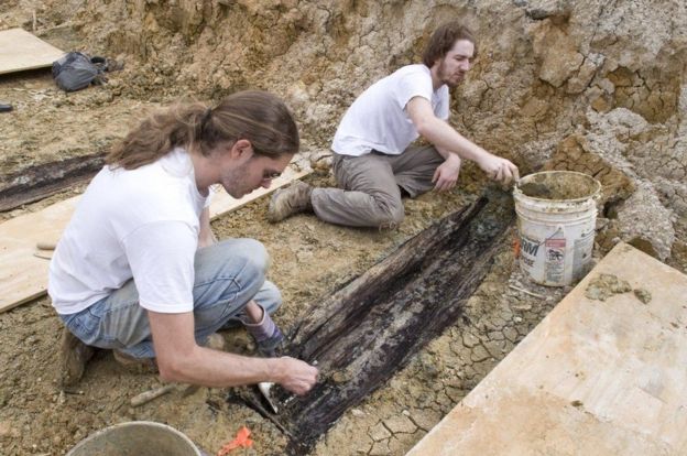 Researchers unearthing coffins