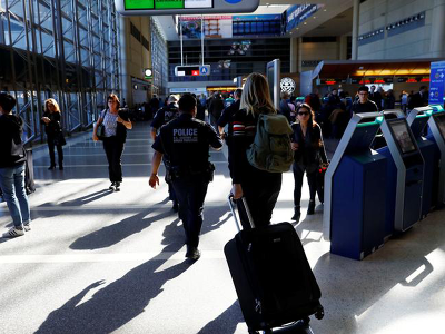 An officer with the US Customs and Border Protection walks past ticket counters at Los Angeles International Airport, California. (Reuters File Photo)